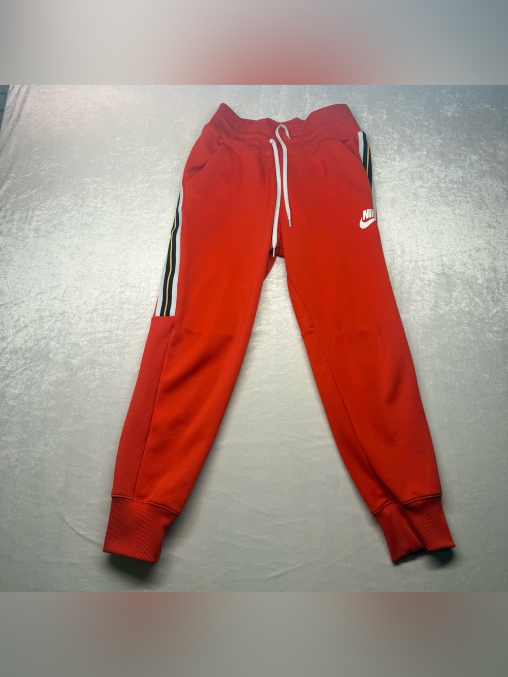 Vibrant Orange Nike Joggers, Contrasting Black and White Side Stripes